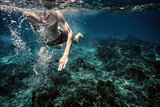 Underwater photo of swimming man