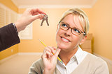 Woman Being Handed Keys in Empty Room with Boxes