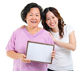 Asian family holding a blank board