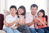 Asian family singing karaoke 