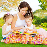 Little kids with mommy read book