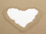 Heart shape drawn in sand with white space for text