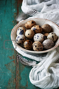 Bowl of quail's eggs on old painted table