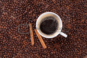 Coffee cup with cinnamon and anise  