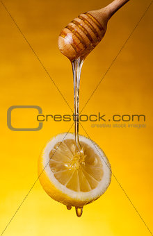 Honey flowing on lemon 