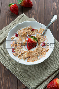 Breakfast cereals with milk and strawberries