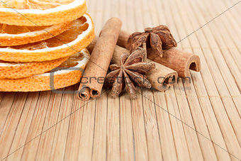 Star Anise, cinnamon and dried orange wooden background 