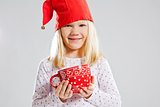 Smiling young girl holding big red cup