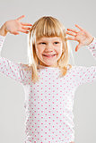 Happy smiling young girl with raised hands