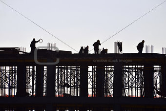 Silhouette of people working and building construction