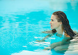 Portrait of young woman in pool looking on copy space