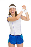 Happy female tennis player rejoicing success