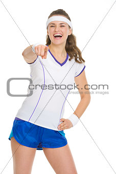 Happy tennis player pointing in camera