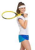 Portrait of smiling tennis player with racket