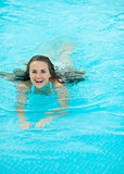 Happy young woman swimming in pool
