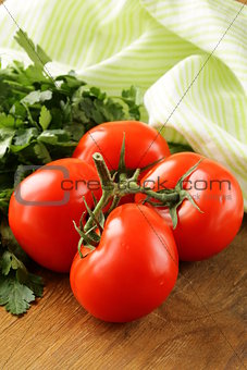 ripe organic tomatoes on a wooden table