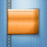 Brown leather label on blue jeans background