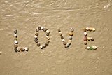 Love stones on sand beach