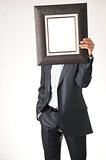 Businessman holding frame