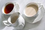 Two cups of tea and milk jug.