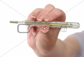 Thermometer in a female hand on a white background