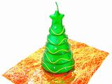 new-year candle in form the decorated fir-tree on a white background