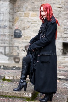 Redhead flirty goth girl in a black coat