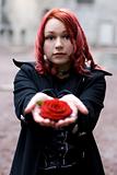 Closeup of redhead girl with a rose