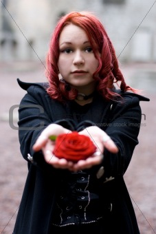 Closeup of redhead girl with a rose