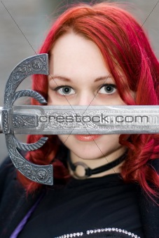 Redhead gothic girl with a ancient sword