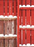 red fence with snow piles