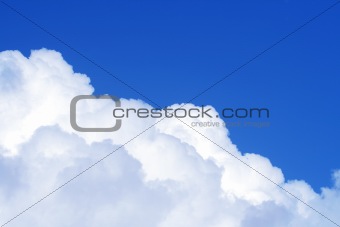 The blue sky and beautiful white clouds.