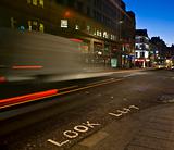 Look Left sign with traffic motion-blur