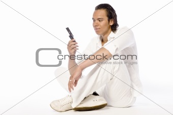 Asian sexy looking boy looking at his mobile