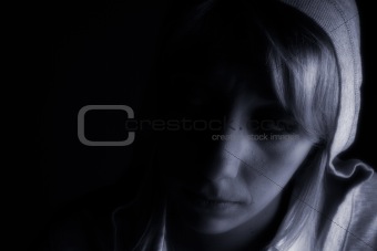 Studio portrait of a long blond girl in the dark