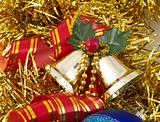 Christmas bells and ribbon on gold tinsel