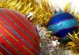 Christmas red and blue ornaments and gold tinsel 