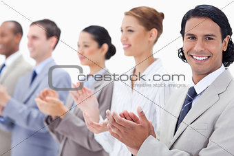 Close-up of a business team smiling and applauding 
