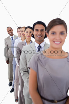 Close-up of workmates in a single line looking straight 