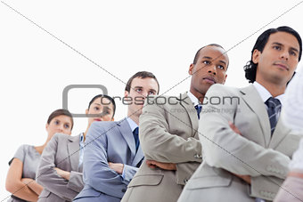 Low-angle shot of a business team crossing their arms in a singl