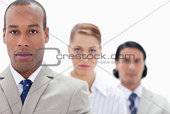 Big close-up of serious people dressed in suits in a single line