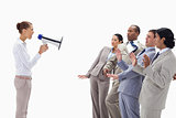 Woman yelling at business people through a megaphone