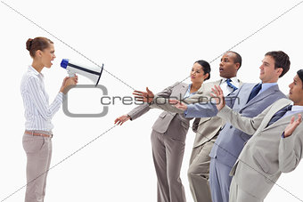 Woman yelling at people dressed in suits through a megaphone