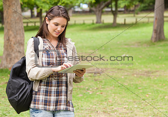 Young female student using a tactile tablet