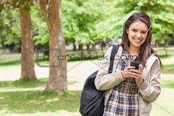 Portrait of a young student using a smartphone
