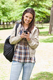 Young smiling student using a smartphone