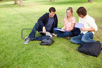 High angle-shot of three students in a park