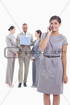 Businesswoman on the phone looking straight ahead with one arm a