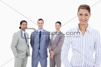 Secretary smiling with business people in background
