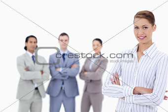 Close-up of a secretary smiling with business people crossing th